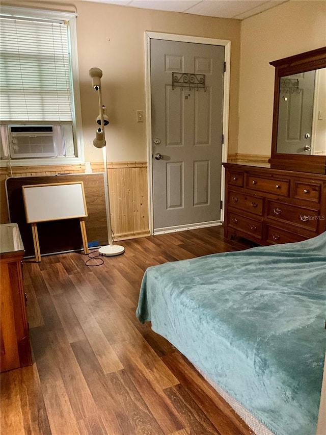 bedroom with wood-type flooring and cooling unit