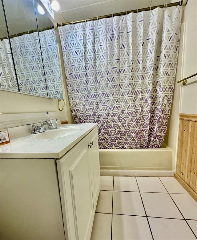 bathroom featuring shower / bath combination with curtain, tile patterned floors, and vanity