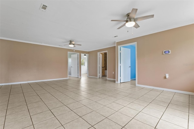 tiled spare room with crown molding and ceiling fan