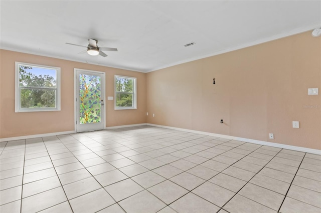 unfurnished room with ceiling fan, light tile patterned floors, and ornamental molding