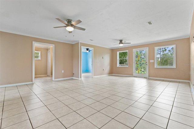 tiled spare room with ceiling fan and ornamental molding