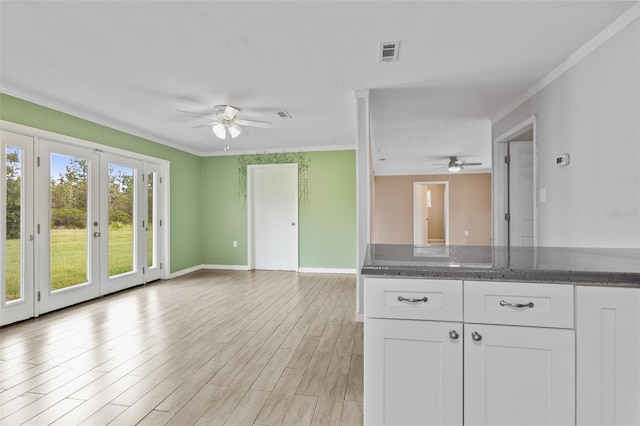 kitchen featuring white cabinetry, a wealth of natural light, ceiling fan, and light hardwood / wood-style floors