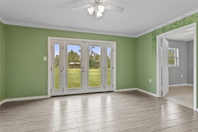 empty room with ceiling fan, light hardwood / wood-style floors, crown molding, and french doors