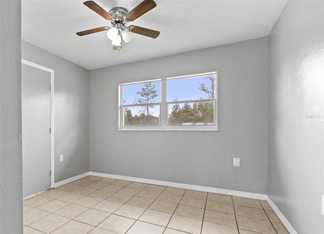 empty room with ceiling fan and light tile patterned flooring