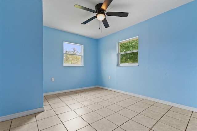 empty room featuring ceiling fan and light tile patterned floors