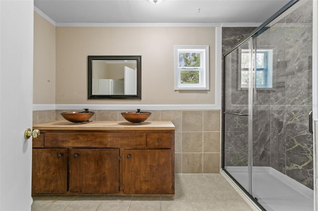 bathroom featuring ornamental molding, vanity, tile walls, and an enclosed shower