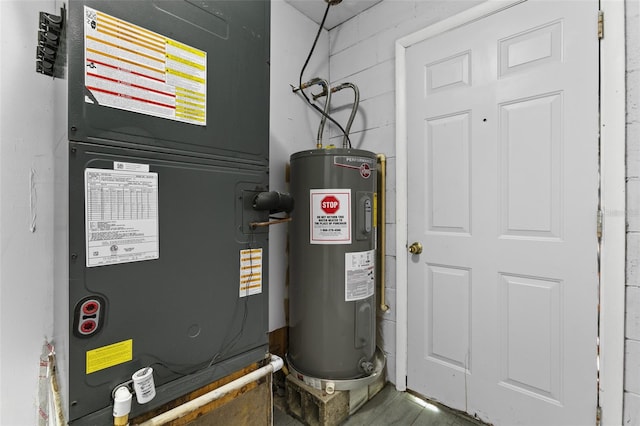 utility room featuring heating unit and water heater