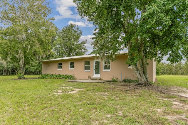 rear view of property with a lawn