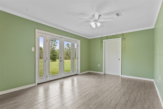 spare room with crown molding, light hardwood / wood-style flooring, ceiling fan, and french doors