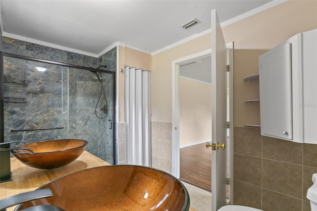 bathroom with an enclosed shower, hardwood / wood-style flooring, toilet, ornamental molding, and vanity