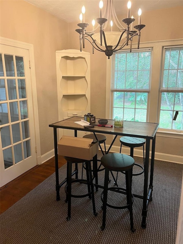 dining space featuring a notable chandelier and hardwood / wood-style flooring