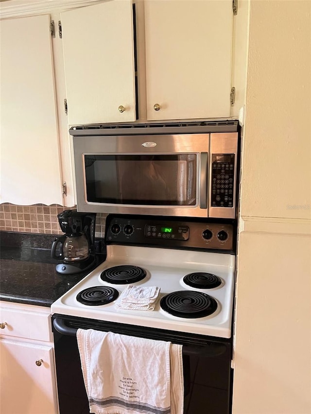 kitchen with electric stove, white cabinetry, and decorative backsplash