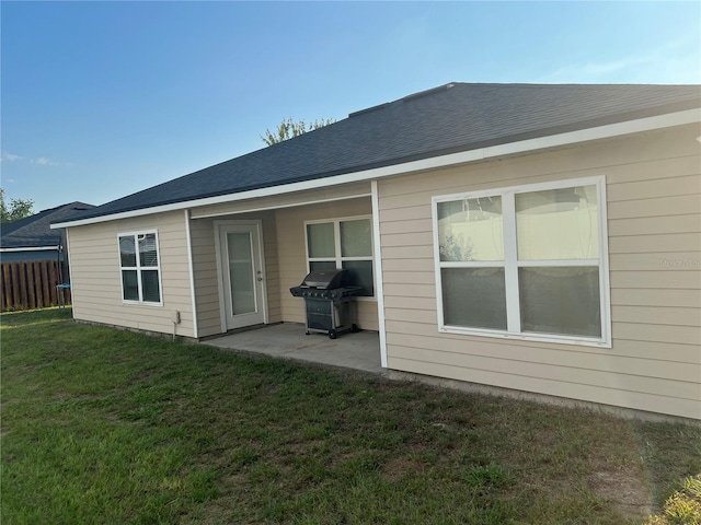 rear view of house with a patio area and a yard