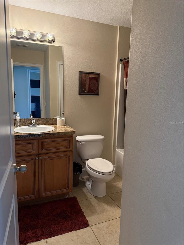 full bathroom featuring toilet, tile patterned flooring, shower / bath combo with shower curtain, and vanity