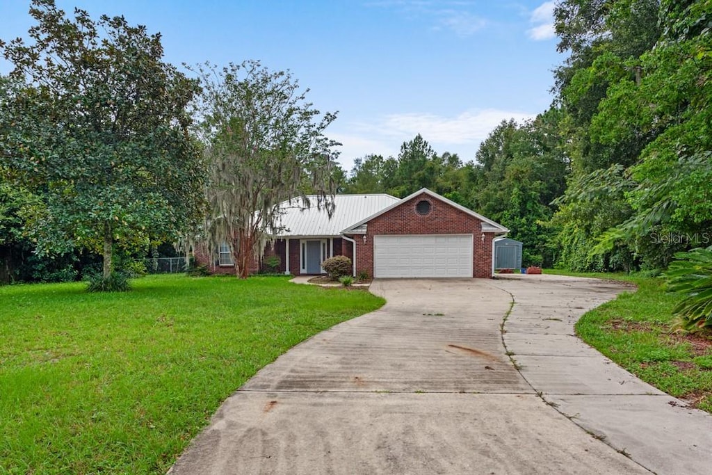 single story home with a front lawn and a garage