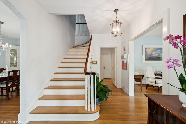 entrance foyer featuring a notable chandelier and light hardwood / wood-style floors