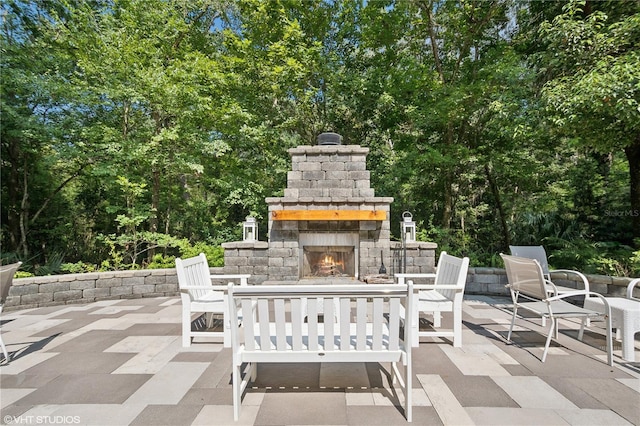 view of patio featuring an outdoor stone fireplace