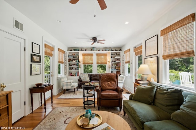 living room featuring hardwood / wood-style floors and ceiling fan