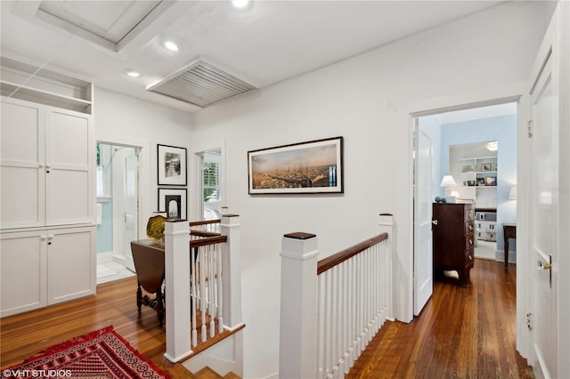 hall with dark wood-type flooring and built in features