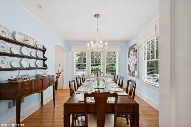 dining area featuring a notable chandelier and light hardwood / wood-style floors