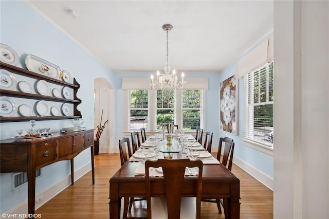 dining area with a chandelier and light hardwood / wood-style floors