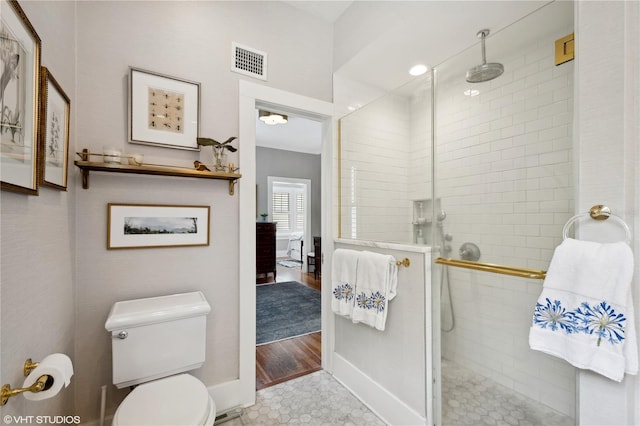 bathroom featuring a shower with shower door, toilet, and hardwood / wood-style floors