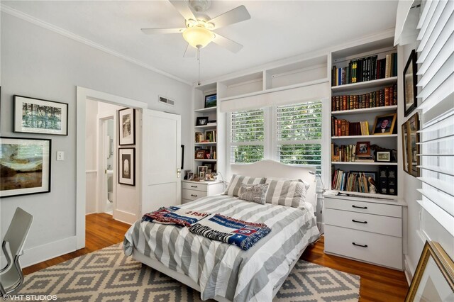 bedroom featuring ceiling fan, wood-type flooring, and crown molding