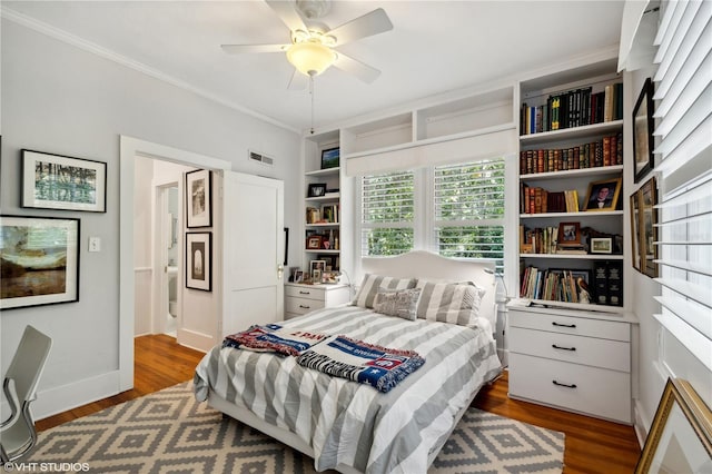 bedroom with dark hardwood / wood-style flooring, ornamental molding, and ceiling fan