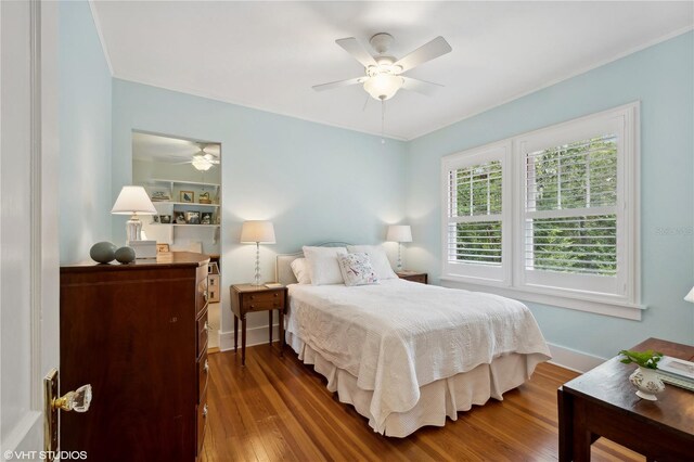 bedroom with ceiling fan and dark wood-type flooring