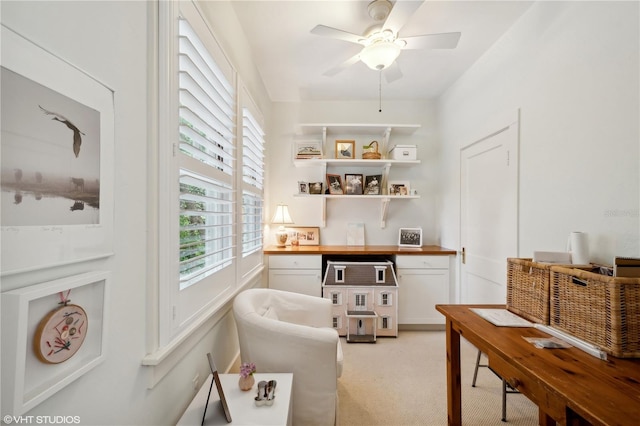 office space with ceiling fan and light colored carpet