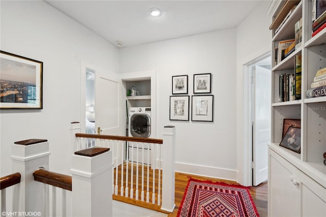 corridor featuring washer / clothes dryer and hardwood / wood-style floors