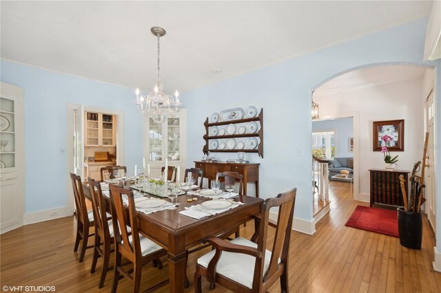 dining space with a chandelier and light hardwood / wood-style floors