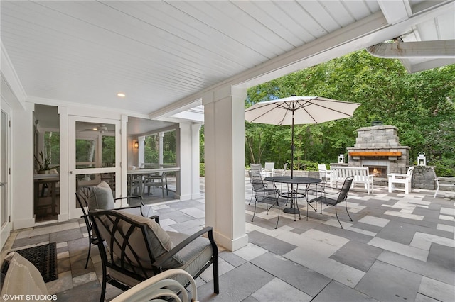 view of patio / terrace featuring an outdoor stone fireplace