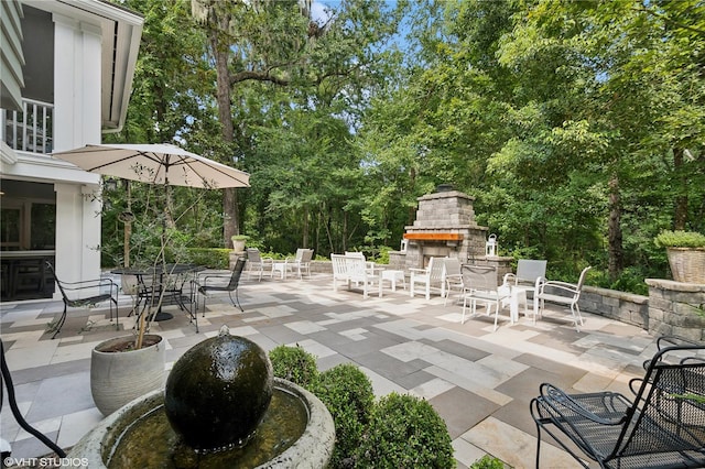 view of patio featuring an outdoor stone fireplace