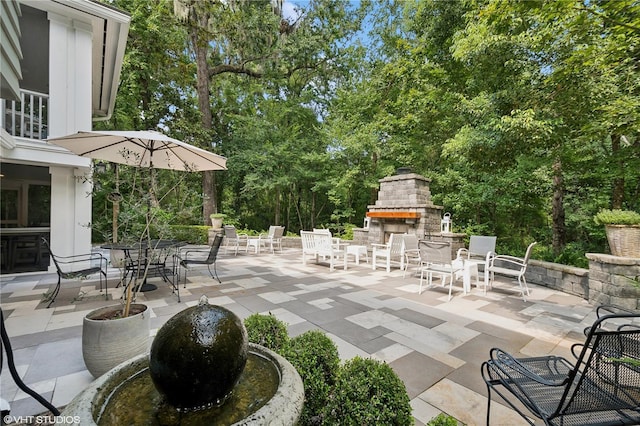 view of patio with an outdoor stone fireplace