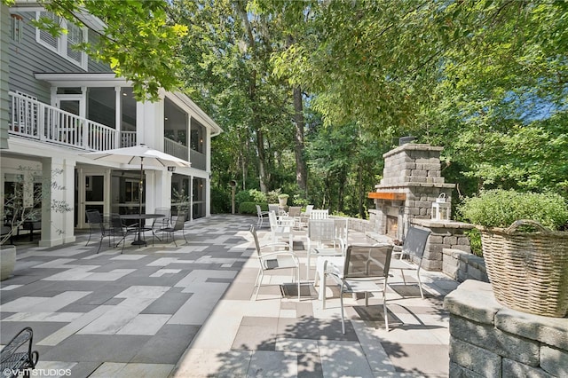 view of patio with an outdoor stone fireplace