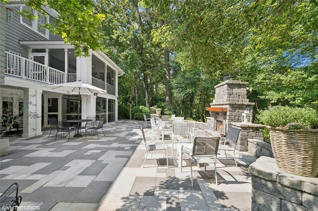 view of patio / terrace with an outdoor stone fireplace