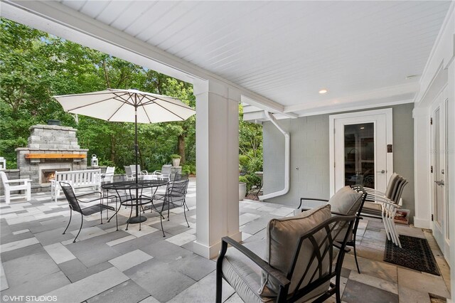 view of patio with an outdoor fireplace