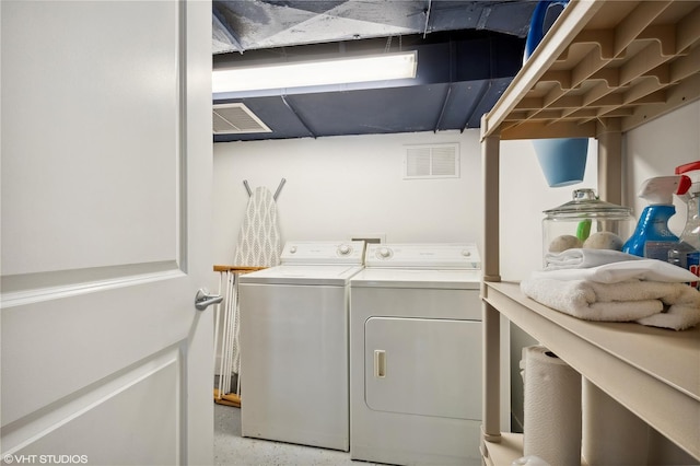 laundry room with separate washer and dryer