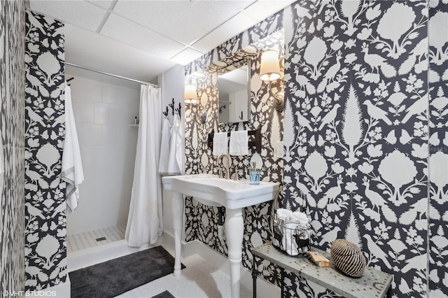 bathroom with a shower with curtain and a paneled ceiling