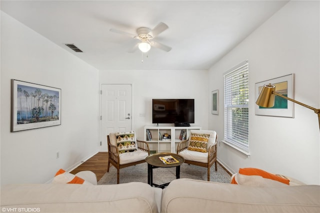 living room with hardwood / wood-style floors and ceiling fan