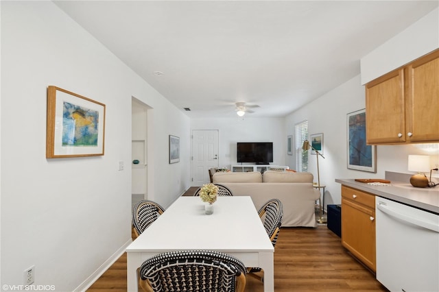 dining area featuring ceiling fan and dark hardwood / wood-style flooring