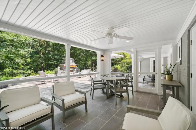 sunroom featuring ceiling fan