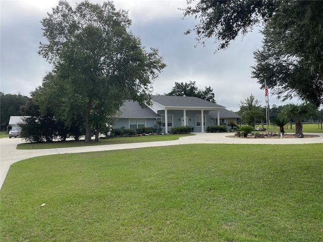 view of front of home with a front yard and driveway