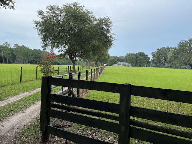 view of gate featuring a yard and a rural view