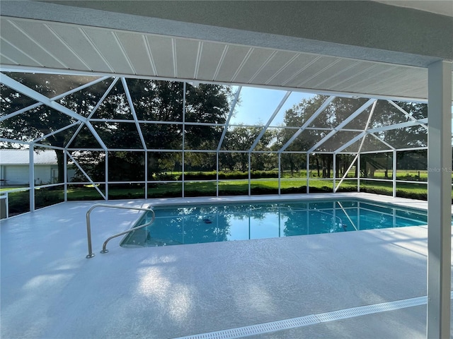 pool with glass enclosure and a patio area