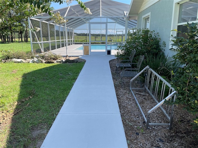 view of yard with a lanai and a fenced in pool