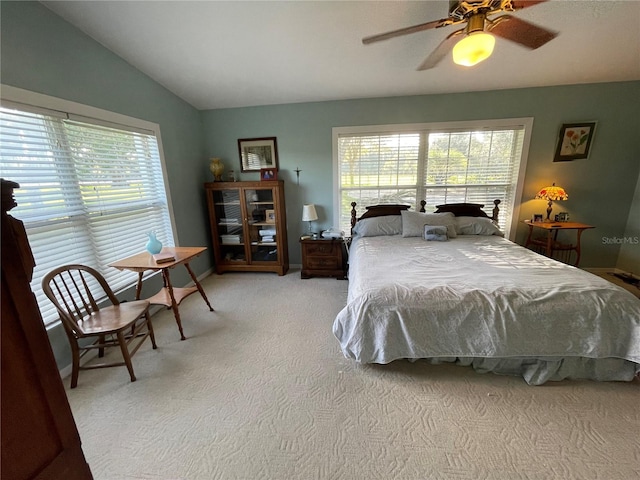 bedroom featuring carpet, multiple windows, baseboards, and vaulted ceiling