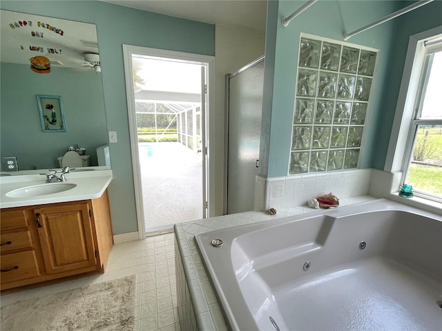 full bath with a stall shower, vanity, a tub with jets, and tile patterned floors