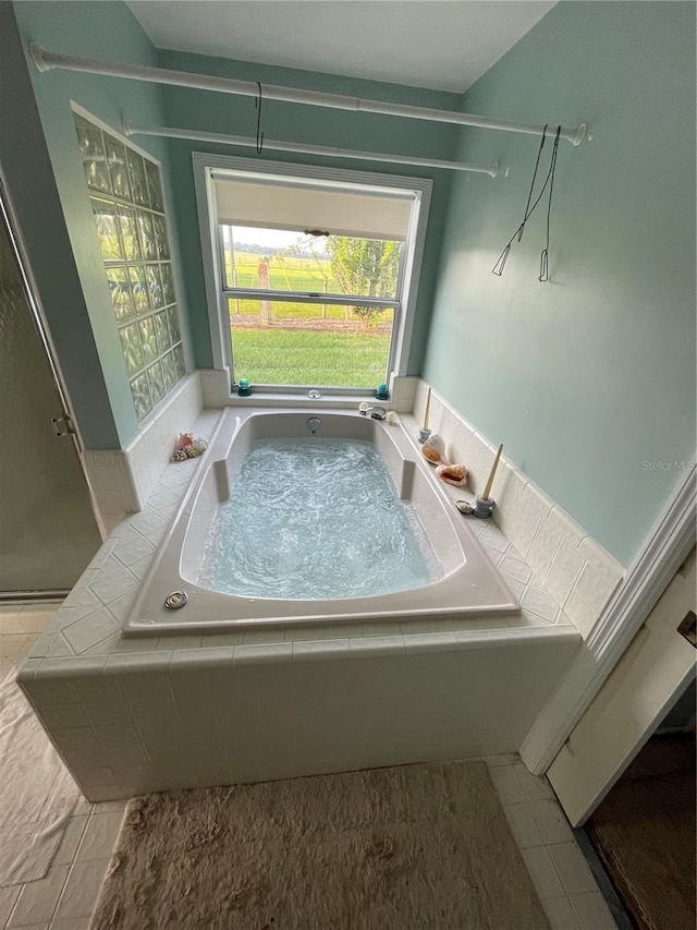 bathroom with tile patterned flooring and independent shower and bath